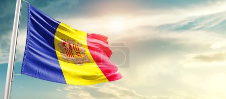 Téléchargez les photos : Andorra waving flag in beautiful sky with sun - en image libre de droit
