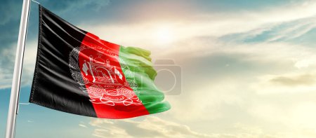 Téléchargez les photos : Afghanistan waving flag in beautiful sky with sun - en image libre de droit