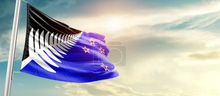 Téléchargez les photos : New Zealand waving flag in beautiful sky with sun - en image libre de droit