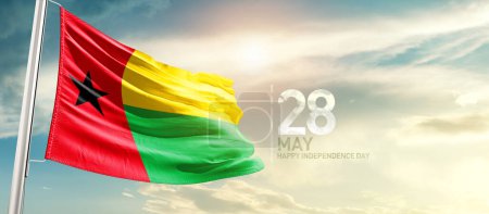Téléchargez les photos : Guinea-Bissau waving flag in beautiful sky with sun - en image libre de droit