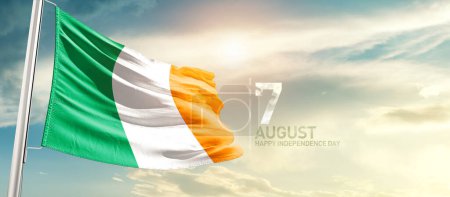 Photo for Ivory Coast Cote d'Ivoire waving flag in beautiful sky with sun - Royalty Free Image