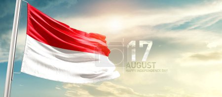Photo for Indonesia waving flag in beautiful sky with sun - Royalty Free Image