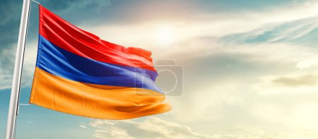 Foto de Armenia waving flag in beautiful sky with sun - Imagen libre de derechos