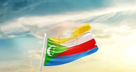 Foto de Comoros waving flag in beautiful sky with sun - Imagen libre de derechos