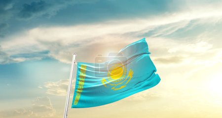 Foto de Kazakhstan waving flag in beautiful sky with sun - Imagen libre de derechos
