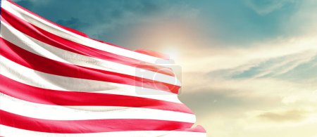 Téléchargez les photos : Liberia waving flag in beautiful sky with sun - en image libre de droit