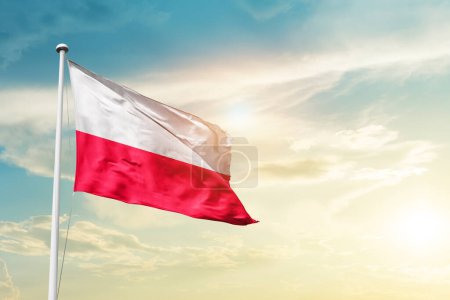 Photo for Poland waving flag in beautiful sky with sun - Royalty Free Image