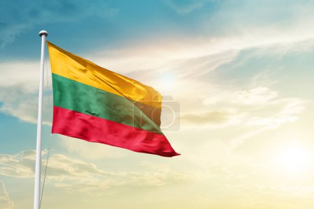 Photo for Lithuania waving flag in beautiful sky with sun - Royalty Free Image