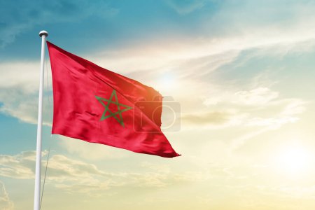 Téléchargez les photos : Morocco waving flag in beautiful sky with sun - en image libre de droit