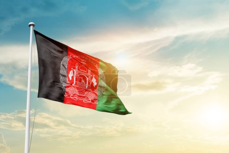 Foto de Afghanistan waving flag in beautiful sky with sun - Imagen libre de derechos