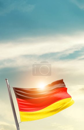 Photo for Germany waving flag in beautiful sky with sun - Royalty Free Image