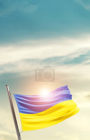 Photo for Ukraine waving flag in beautiful sky with sun - Royalty Free Image