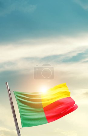 Téléchargez les photos : Benin waving flag in beautiful sky with sun - en image libre de droit