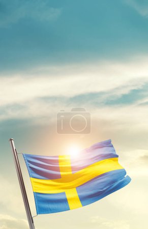 Foto de Sweden waving flag in beautiful sky with sun - Imagen libre de derechos