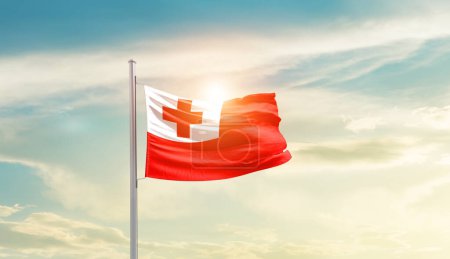 Foto de Tonga waving flag in beautiful sky with sun - Imagen libre de derechos