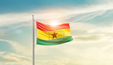 Photo for Ghana waving flag in beautiful sky with sun - Royalty Free Image