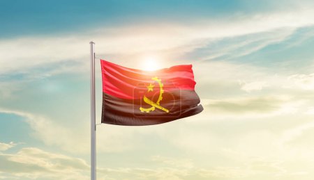 Téléchargez les photos : Angola waving flag in beautiful sky with sun - en image libre de droit