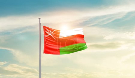 Photo for Oman waving flag in beautiful sky with sun - Royalty Free Image