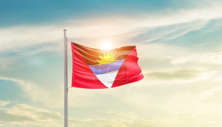 Photo for Antigua and Barbuda waving flag in beautiful sky with sun - Royalty Free Image