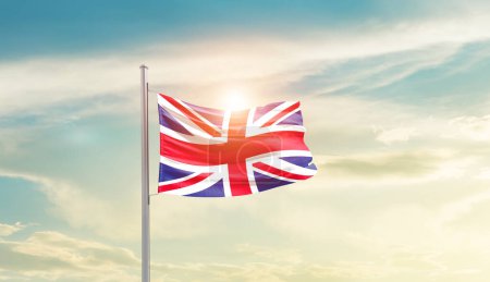 Photo for United Kingdom waving flag in beautiful sky with sun - Royalty Free Image