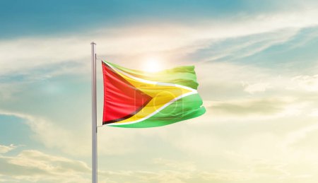 Guyana waving flag in beautiful sky with sun