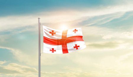 Téléchargez les photos : Géorgie agitant drapeau dans un ciel magnifique avec le soleil - en image libre de droit