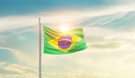 Foto de Brazil waving flag in beautiful sky with sun - Imagen libre de derechos