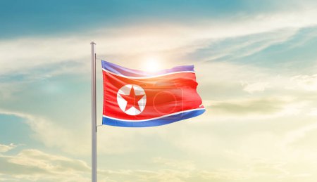 Téléchargez les photos : North Korea waving flag in beautiful sky with sun - en image libre de droit