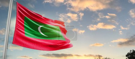 Photo for Maldives waving flag in beautiful sky with clouds - Royalty Free Image