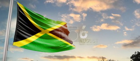 Téléchargez les photos : Jamaïque agitant le drapeau dans un ciel magnifique avec des nuages - en image libre de droit