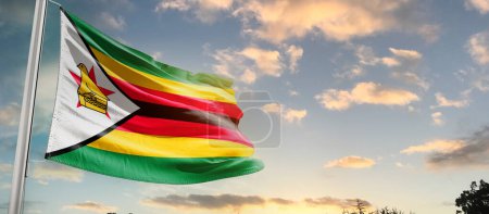 Zimbabwe waving flag in beautiful sky with clouds