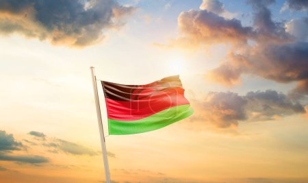 Photo for Malawi waving flag in beautiful sky with clouds and sun - Royalty Free Image