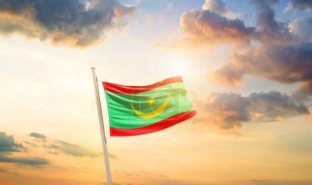 Photo for Mauritania waving flag in beautiful sky with clouds and sun - Royalty Free Image
