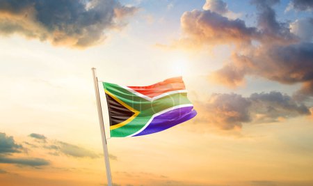 Foto de Sudáfrica ondeando bandera en el hermoso cielo con nubes y sol - Imagen libre de derechos