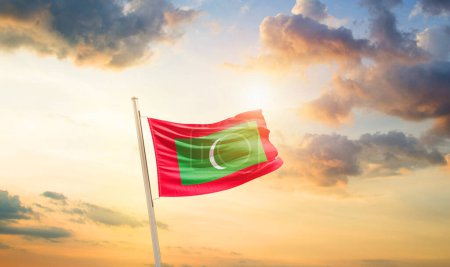 Photo for Maldives waving flag in beautiful sky with clouds and sun - Royalty Free Image