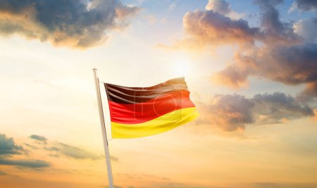 Photo for Germany waving flag in beautiful sky with clouds and sun - Royalty Free Image