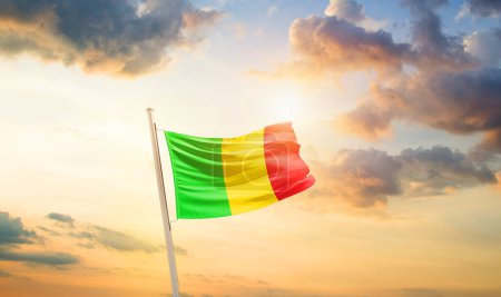Mali waving flag in beautiful sky with clouds and sun
