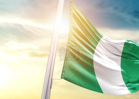 Photo for Nigeria flag against sky with sun - Royalty Free Image