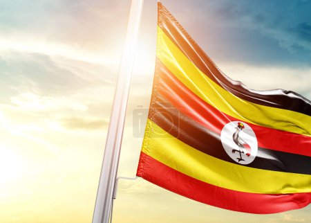 Photo for Uganda flag against sky with sun - Royalty Free Image