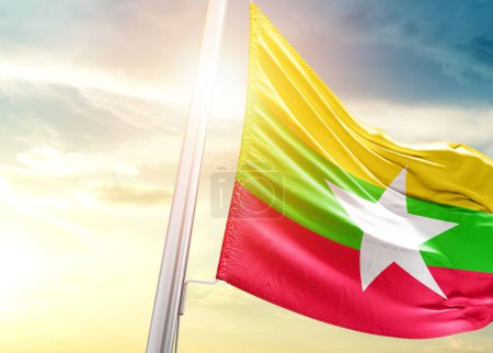 Foto de Bandera de Myanmar contra el cielo con sol - Imagen libre de derechos