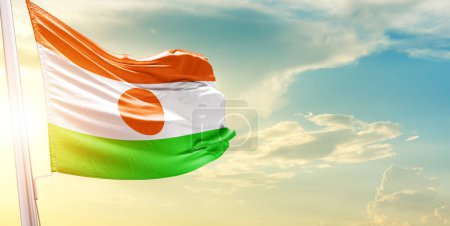 Photo for Niger flag against sky with clouds and sun - Royalty Free Image