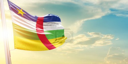 Photo for Central African Republic flag against sky with clouds and sun - Royalty Free Image