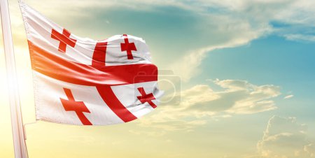 Photo for Georgia flag against sky with clouds and sun - Royalty Free Image