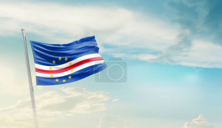 Téléchargez les photos : Cabo Verde agitant le drapeau contre le ciel bleu avec des nuages - en image libre de droit