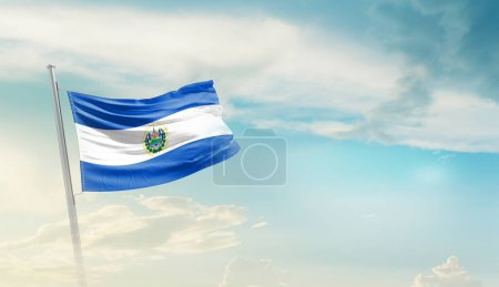 El Salvador waving flag against blue sky with clouds