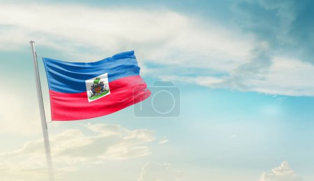 Haiti waving flag against blue sky with clouds