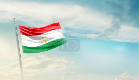 Tajikistan waving flag against blue sky with clouds