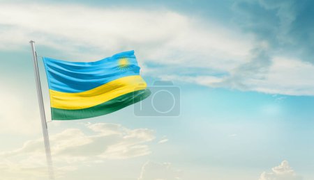 Téléchargez les photos : Rwanda agitant le drapeau contre le ciel bleu avec des nuages - en image libre de droit
