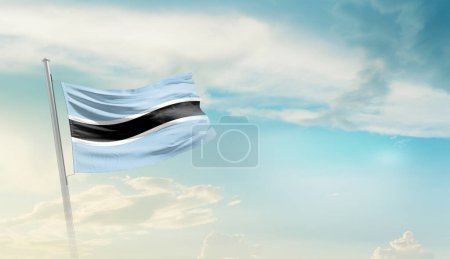 Botswana waving flag against blue sky with clouds