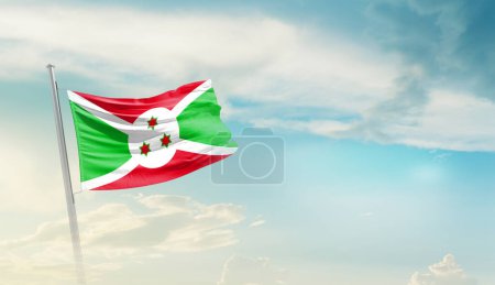 Burundi agitant le drapeau contre le ciel bleu avec des nuages 